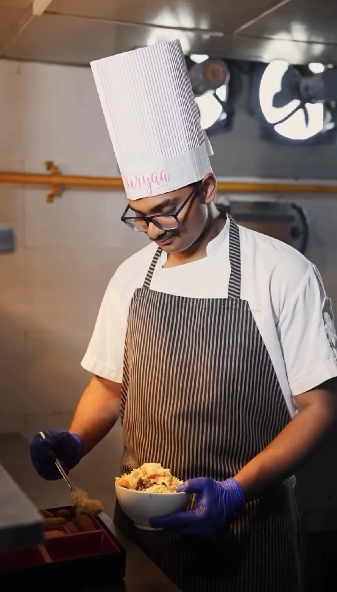 A SUVAIRA chef controlling the fry in a professional kitchen